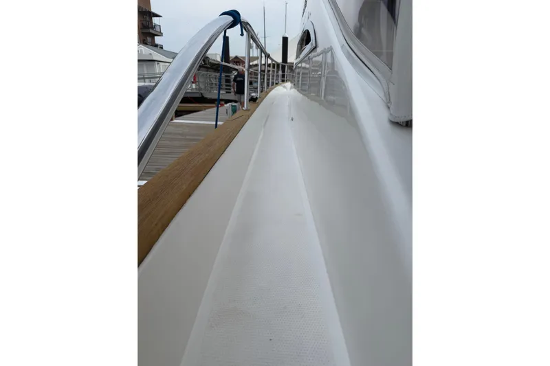 Habibi Yacht Photos Pics Side deck view of 2017 Belize 54 Daybridge yacht, featuring sleek design and polished railings.