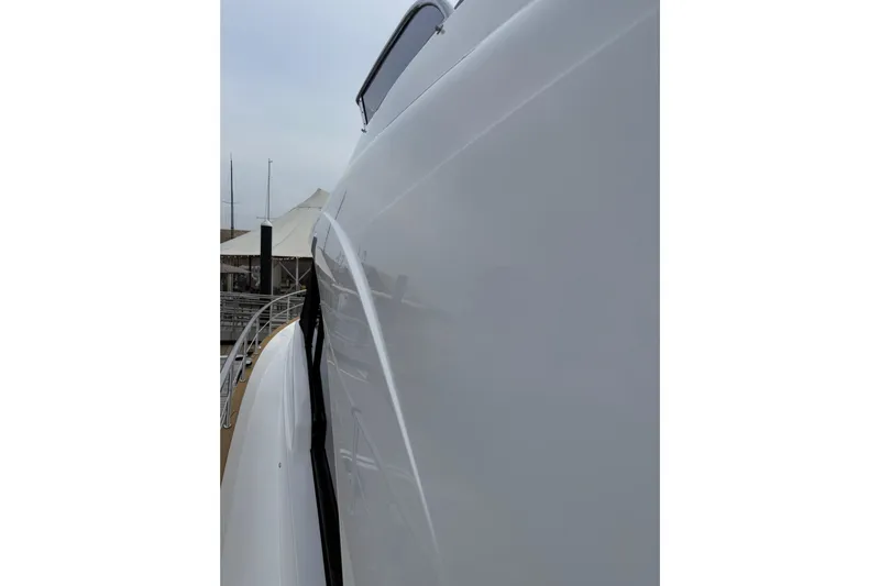 Habibi Yacht Photos Pics Side view of a 2017 Belize 54 Daybridge yacht, showcasing sleek design and glossy finish.