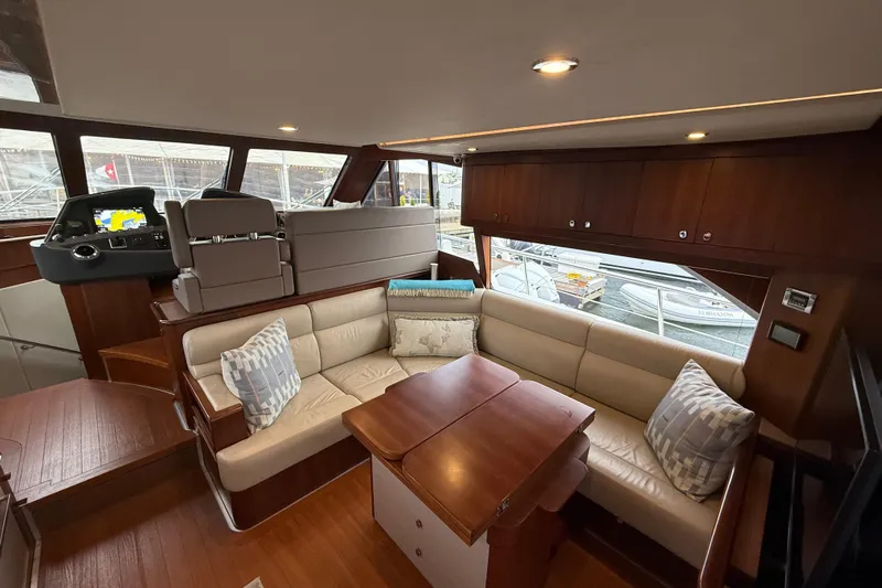 Habibi Yacht Photos Pics Luxurious interior of 2017 Belize 54 Daybridge yacht with plush seating and elegant wood finishes.