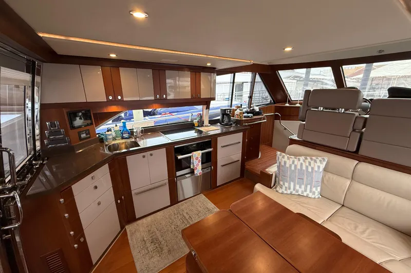 Habibi Yacht Photos Pics Luxurious interior of 2017 Belize 54 Daybridge yacht with modern kitchen and seating area.