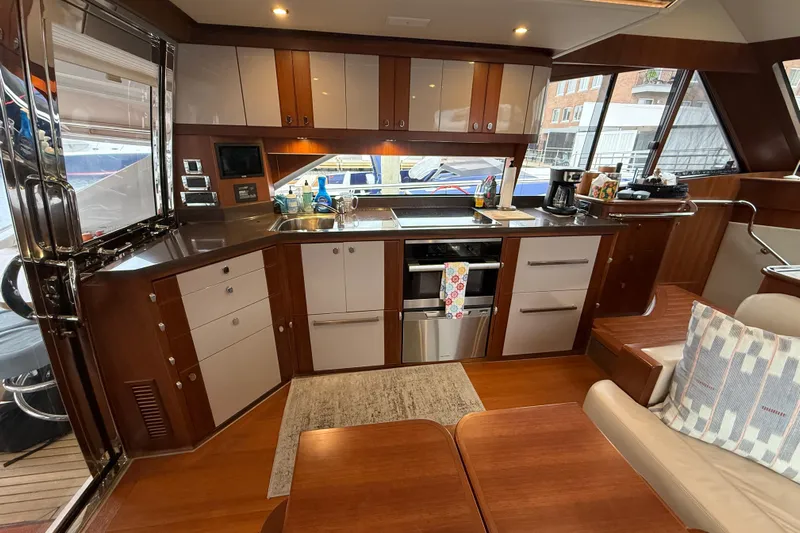 Habibi Yacht Photos Pics Luxurious kitchen interior of 2017 Belize 54 Daybridge yacht with modern appliances and wood finish.