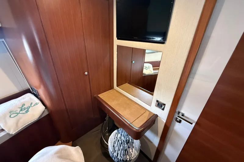 Habibi Yacht Photos Pics Interior of 2017 Belize 54 Daybridge yacht with wooden cabinetry and wall-mounted TV.