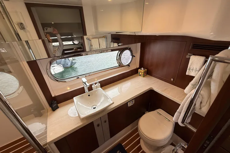 Habibi Yacht Photos Pics Luxurious bathroom interior of 2017 Belize 54 Daybridge yacht with elegant fixtures and porthole view.