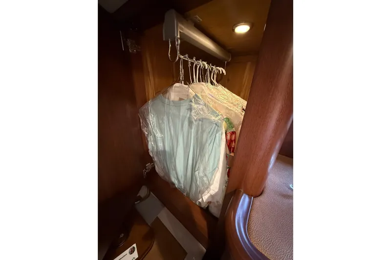 Habibi Yacht Photos Pics Clothes hanging in a wooden closet on a 2017 Belize 54 Daybridge yacht.