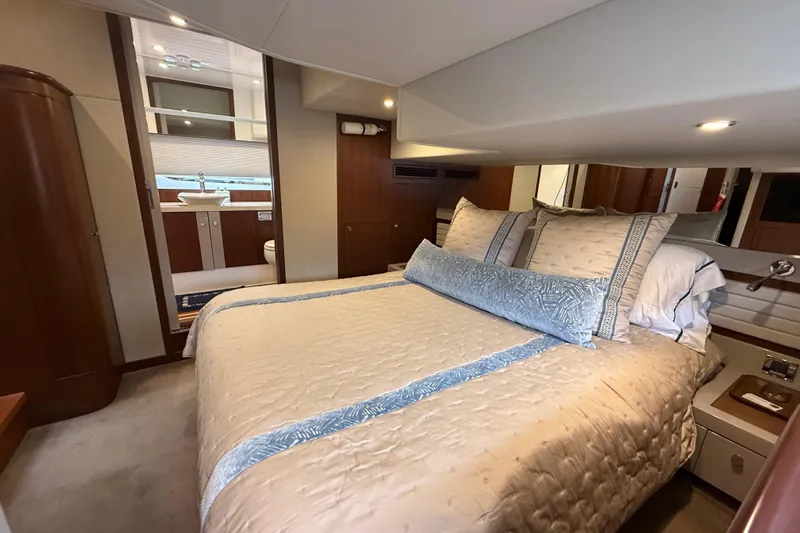 Habibi Yacht Photos Pics Luxurious bedroom interior of 2017 Belize 54 Daybridge yacht with elegant bedding and ensuite bathroom.