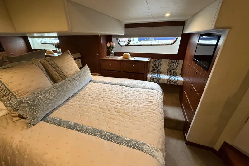 Habibi Yacht Photos Pics Luxurious bedroom interior of 2017 Belize 54 Daybridge yacht with elegant bedding and wood finishes.