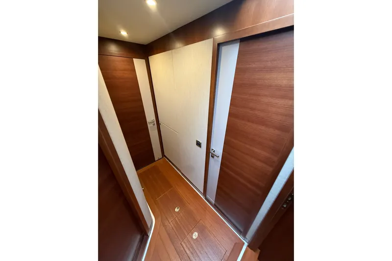 Habibi Yacht Photos Pics Interior hallway of 2017 Belize 54 Daybridge yacht with wooden doors and flooring.