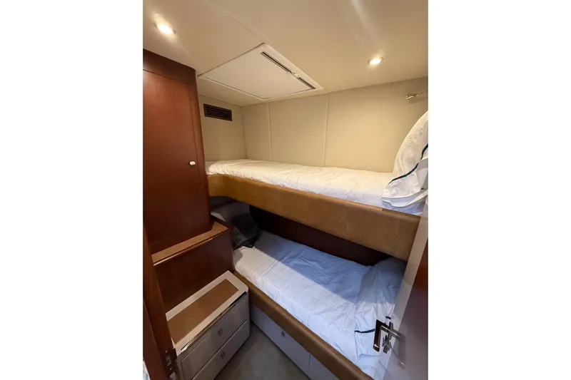 Habibi Yacht Photos Pics Bunk beds in 2017 Belize 54 Daybridge yacht cabin, featuring wooden cabinetry and soft lighting.