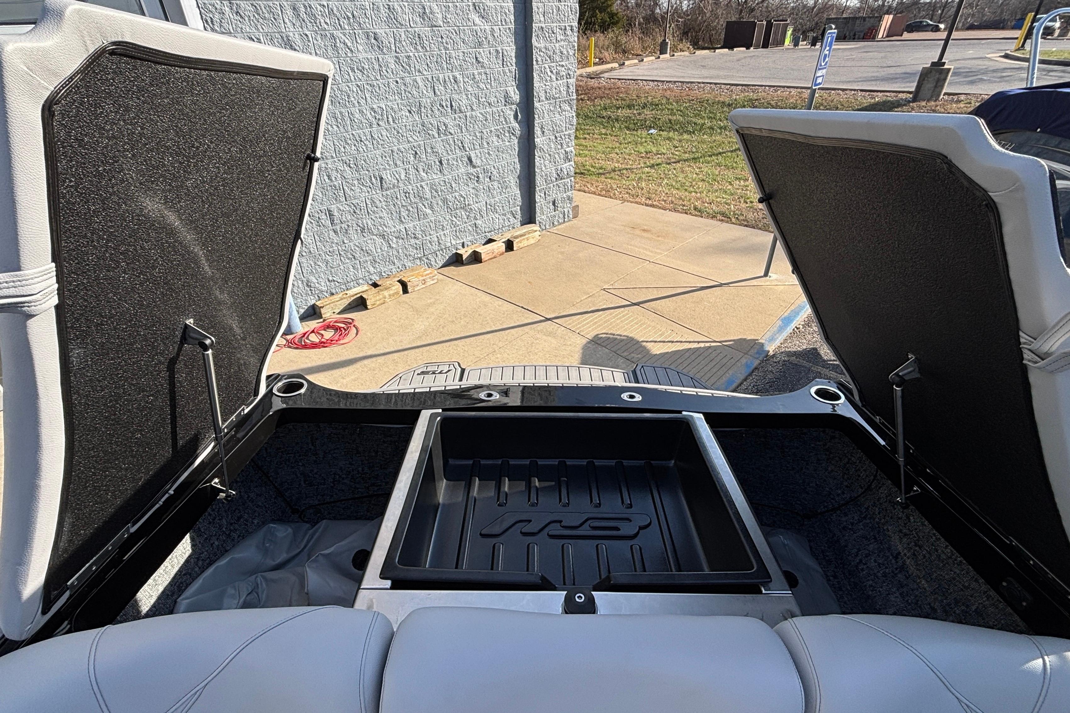 2026 MB B52 23 Classic boat storage compartment open, showcasing interior space.