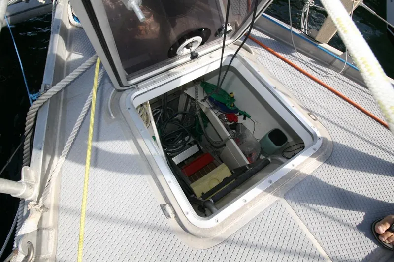 Espresso Yacht Photos Pics Open hatch on 2019 Custom Southwell Sovereign 51 sailboat deck, revealing storage compartment.