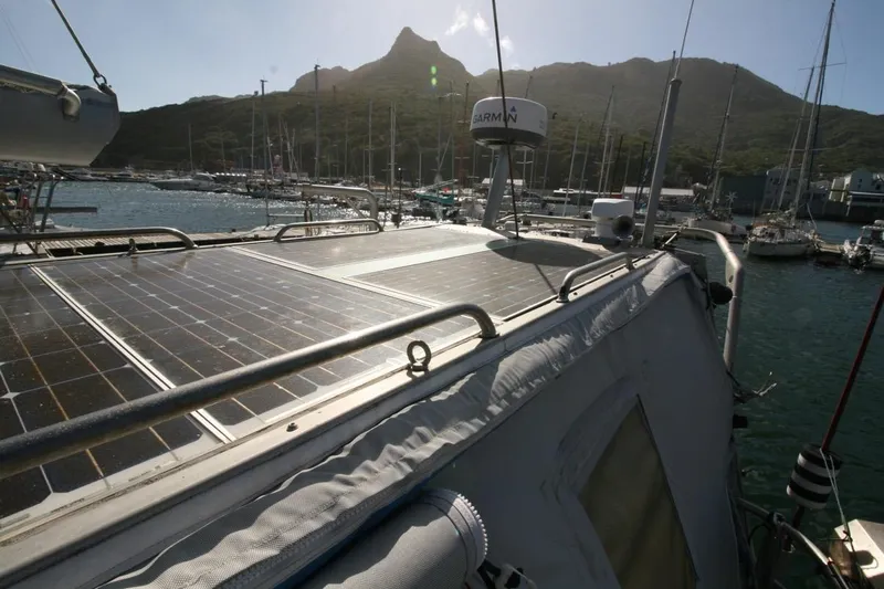 Espresso Yacht Photos Pics Sailboat with solar panels docked in a marina, mountainous backdrop, Southwell Sovereign 51, 2019.