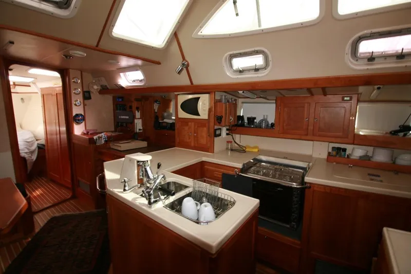Espresso Yacht Photos Pics Luxurious 2019 Southwell Sovereign 51 yacht interior with modern kitchen and wooden cabinetry.