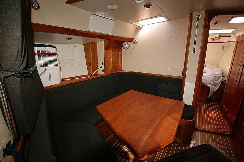 Espresso Yacht Photos Pics Cozy interior of 2019 Custom Southwell Sovereign 51 yacht with wooden table and seating area.
