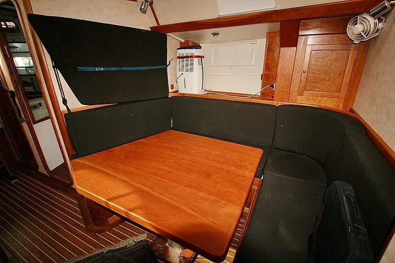 Espresso Yacht Photos Pics Cozy interior of 2019 Custom Southwell Sovereign 51 yacht with wooden table and seating.