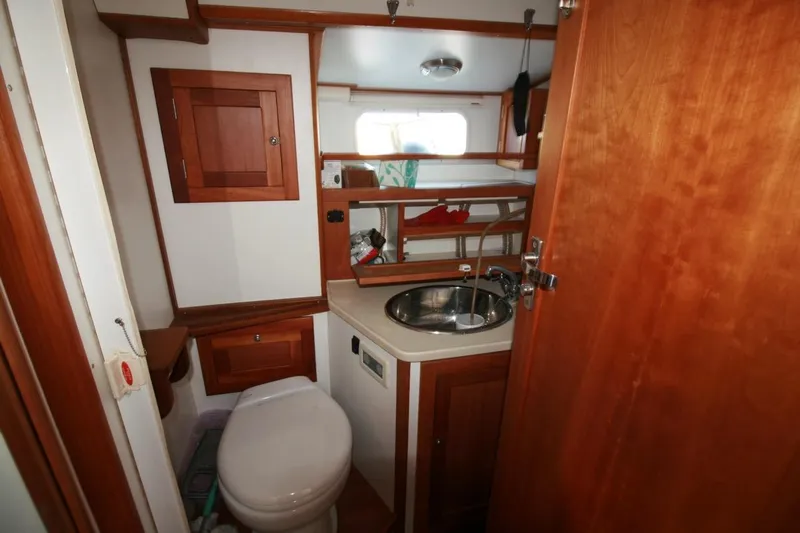 Espresso Yacht Photos Pics 2019 Southwell Sovereign 51 yacht bathroom with wooden cabinetry and stainless steel sink.