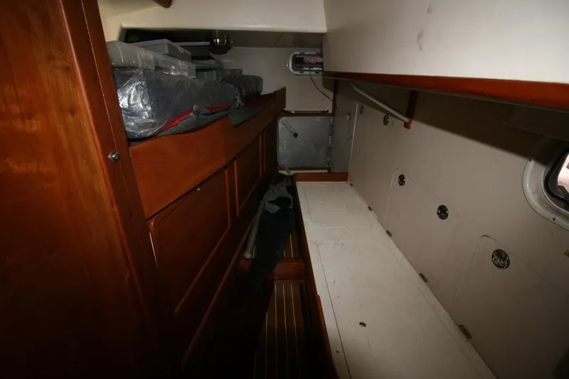 Espresso Yacht Photos Pics Interior cabin of 2019 Custom Southwell Sovereign 51 yacht, featuring wooden storage and compact design.