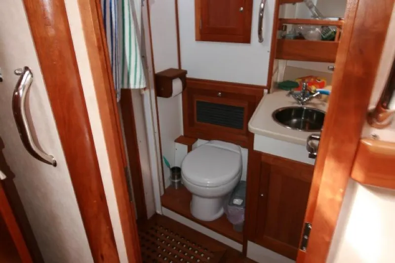 Espresso Yacht Photos Pics Compact bathroom in 2019 Southwell Sovereign 51 yacht with wooden cabinetry and modern fixtures.