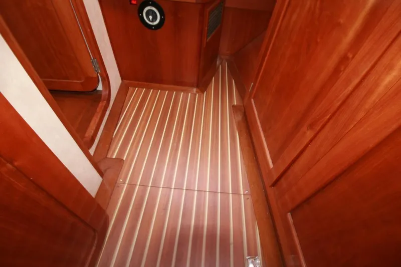 Espresso Yacht Photos Pics Wooden interior of 2019 Custom Southwell Sovereign 51 yacht, featuring striped flooring.
