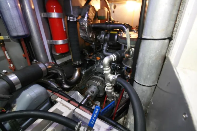 Espresso Yacht Photos Pics Engine room of 2019 Custom Southwell Sovereign 51 yacht, featuring complex piping and fire extinguisher.