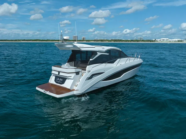  Yacht Photos Pics 2022 Galeon 425 HTS yacht cruising on open water under a clear blue sky.