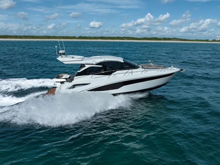  Yacht Photos Pics 2022 Galeon 425 HTS yacht cruising on open water under a clear blue sky.