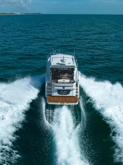  Yacht Photos Pics 2022 Galeon 425 HTS yacht cruising on open sea, leaving a wake behind.