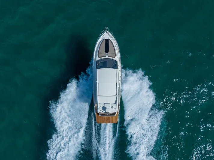  Yacht Photos Pics Aerial view of 2022 Galeon 425 HTS yacht cruising on turquoise water.