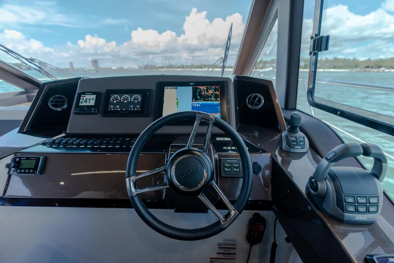  Yacht Photos Pics Helm of 2022 Galeon 425 HTS yacht with modern navigation controls and steering wheel.