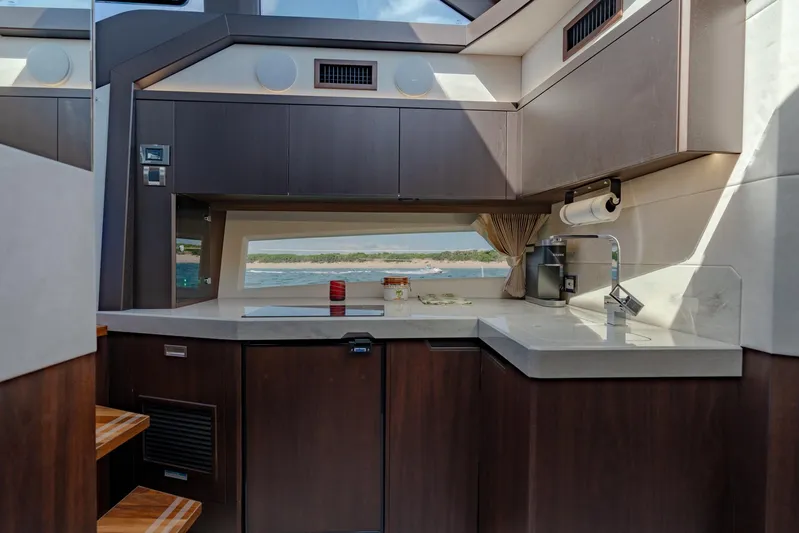  Yacht Photos Pics Modern kitchen interior of 2022 Galeon 425 HTS yacht with sleek cabinetry and ocean view.