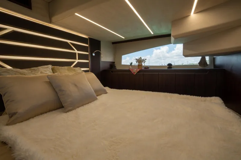  Yacht Photos Pics Luxurious bedroom interior of 2022 Galeon 425 HTS yacht with modern lighting and window view.