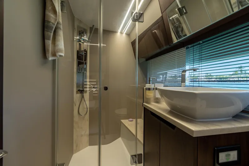  Yacht Photos Pics Luxurious bathroom in 2022 Galeon 425 HTS yacht with modern fixtures and glass shower.