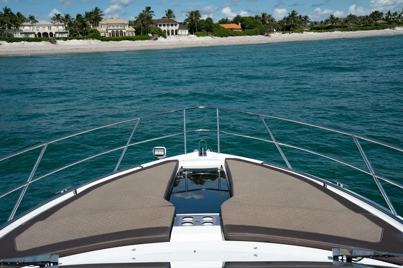  Yacht Photos Pics 2022 Galeon 425 HTS yacht cruising near a scenic coastline.