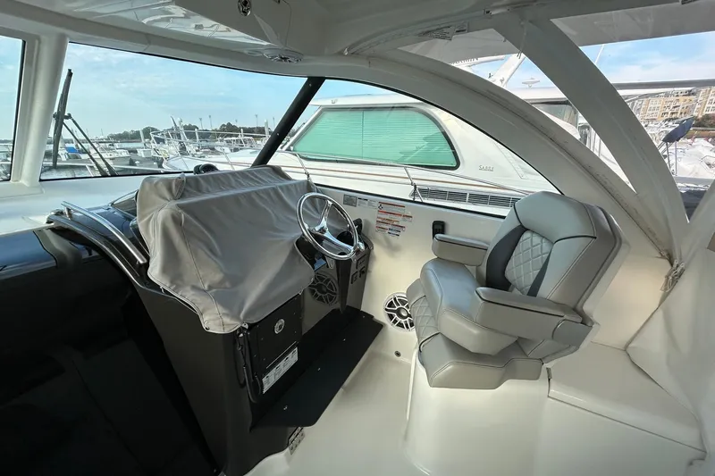  Yacht Photos Pics 2023 Pursuit OS 385 Offshore helm with covered controls and luxurious seating.