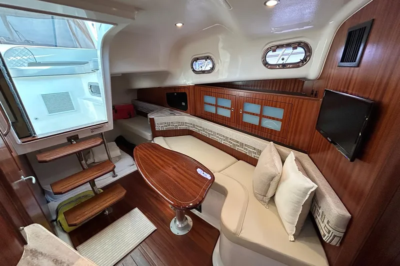  Yacht Photos Pics Luxurious interior of 2023 Pursuit OS 385 Offshore boat with elegant seating and wooden finishes.
