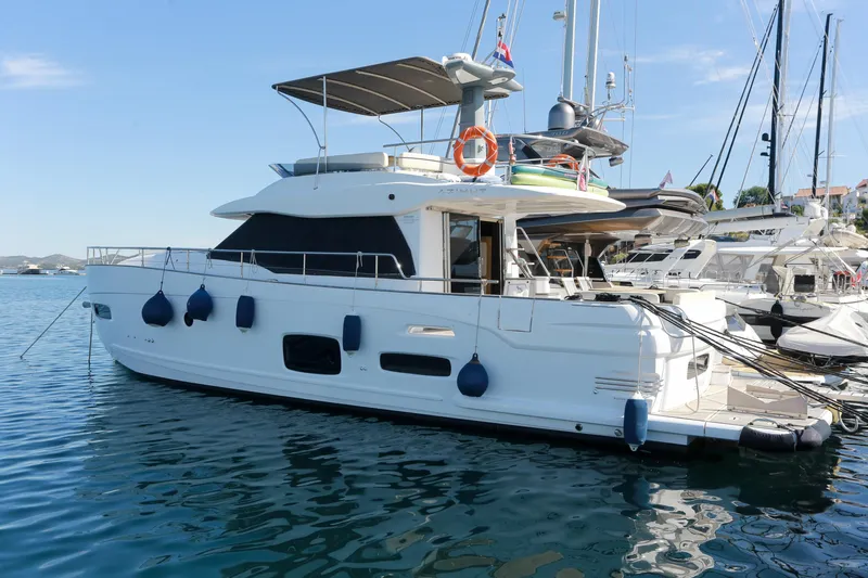  Yacht Photos Pics 2019 Azimut Magellano 53 yacht docked in a marina, side view.