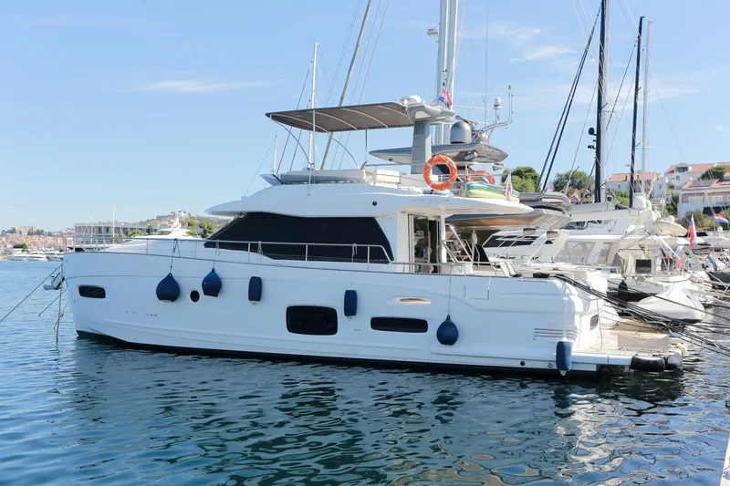  Yacht Photos Pics 2019 Azimut Magellano 53 yacht docked in a marina under clear blue skies.