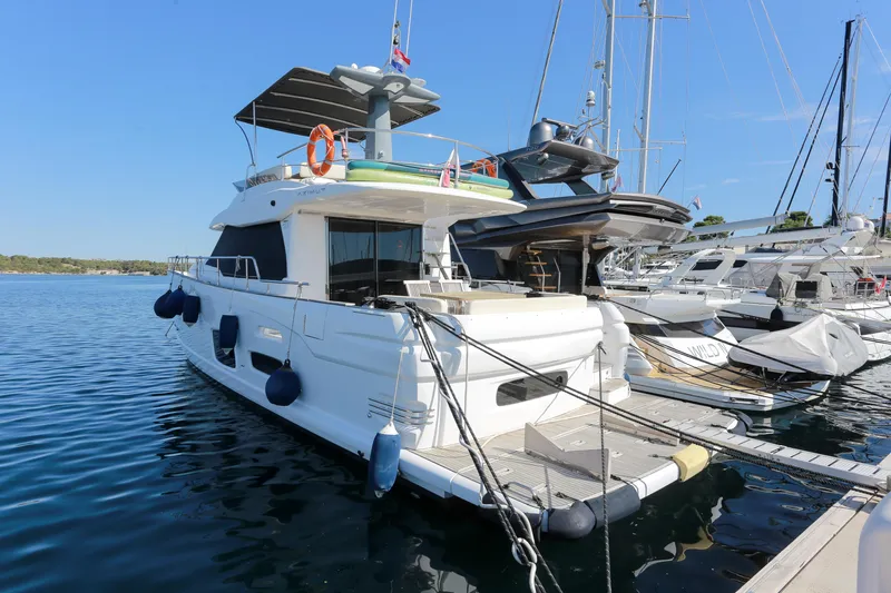  Yacht Photos Pics 2019 Azimut Magellano 53 yacht docked at marina, clear blue sky, calm water.