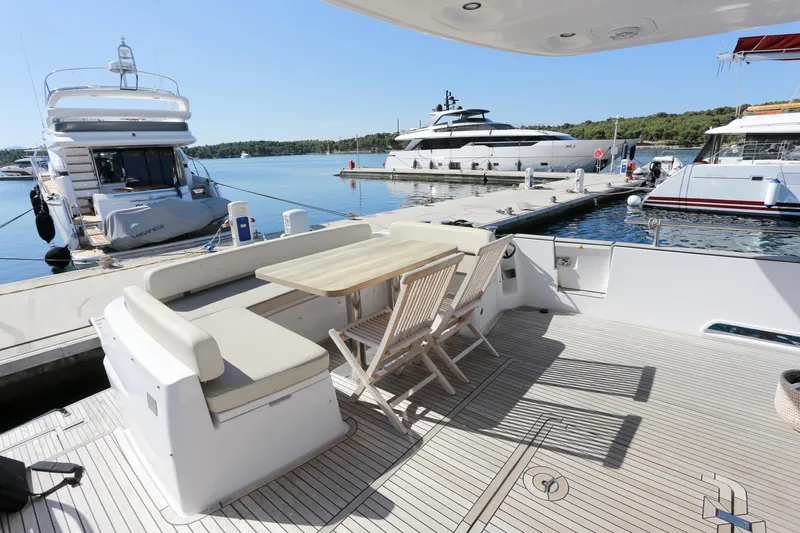  Yacht Photos Pics Azimut Magellano 53 yacht deck with seating and table, docked at marina, 2019 model.