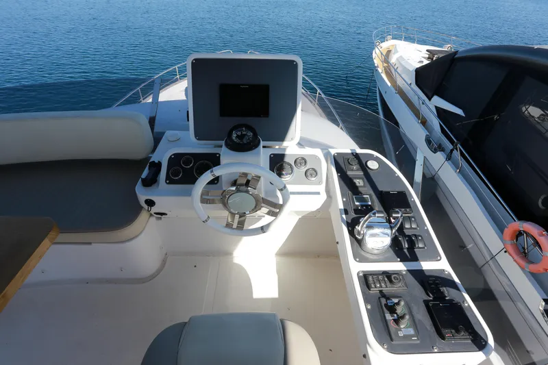  Yacht Photos Pics Cockpit of 2019 Azimut Magellano 53 yacht with steering wheel and control panel.