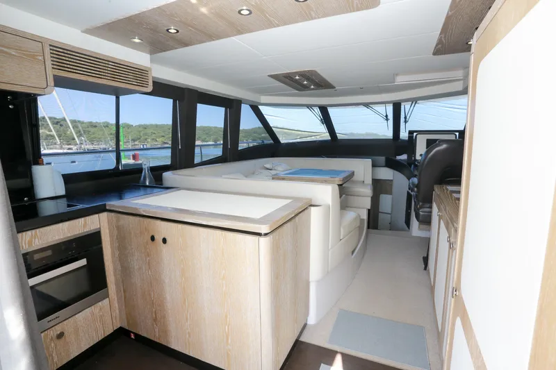  Yacht Photos Pics Luxurious interior of 2019 Azimut Magellano 53 yacht with modern kitchen and seating area.