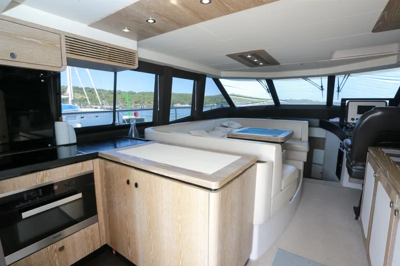  Yacht Photos Pics Luxurious interior of 2019 Azimut Magellano 53 yacht with modern kitchen and seating area.