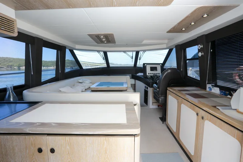 Yacht Photos Pics Luxurious interior of 2019 Azimut Magellano 53 yacht with modern furnishings and panoramic windows.