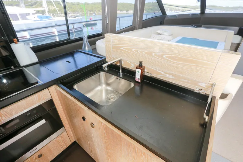  Yacht Photos Pics Modern kitchen area on 2019 Azimut Magellano 53 yacht with sink and appliances.