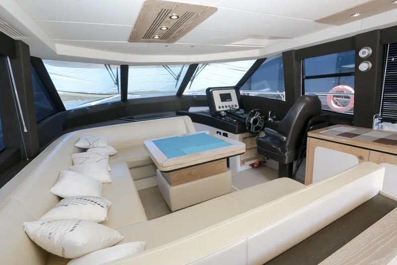  Yacht Photos Pics Luxurious interior of 2019 Azimut Magellano 53 yacht with modern seating and navigation area.