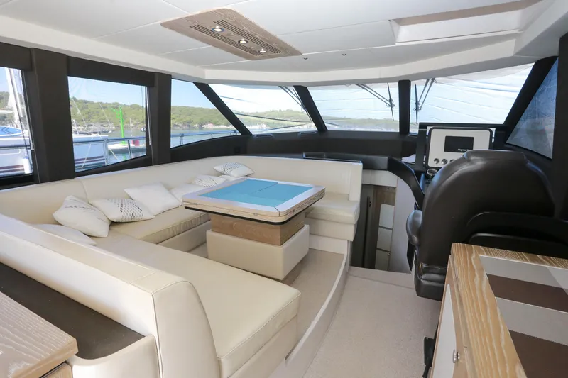  Yacht Photos Pics Luxurious interior of 2019 Azimut Magellano 53 yacht with elegant seating and navigation area.