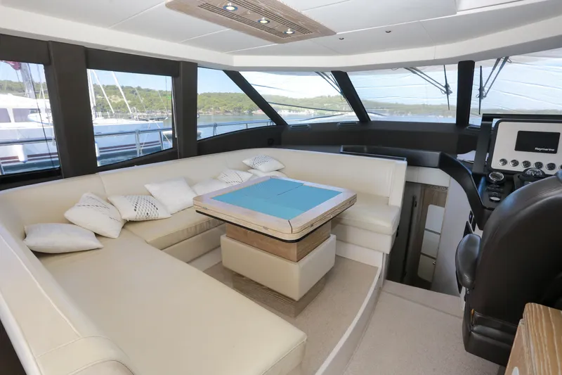  Yacht Photos Pics Luxurious interior of 2019 Azimut Magellano 53 yacht with elegant seating and navigation area.