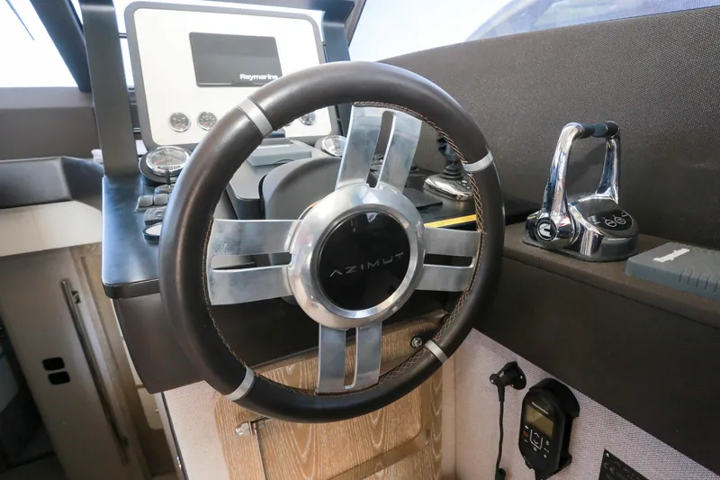  Yacht Photos Pics Steering wheel and controls of 2019 Azimut Magellano 53 yacht cockpit.
