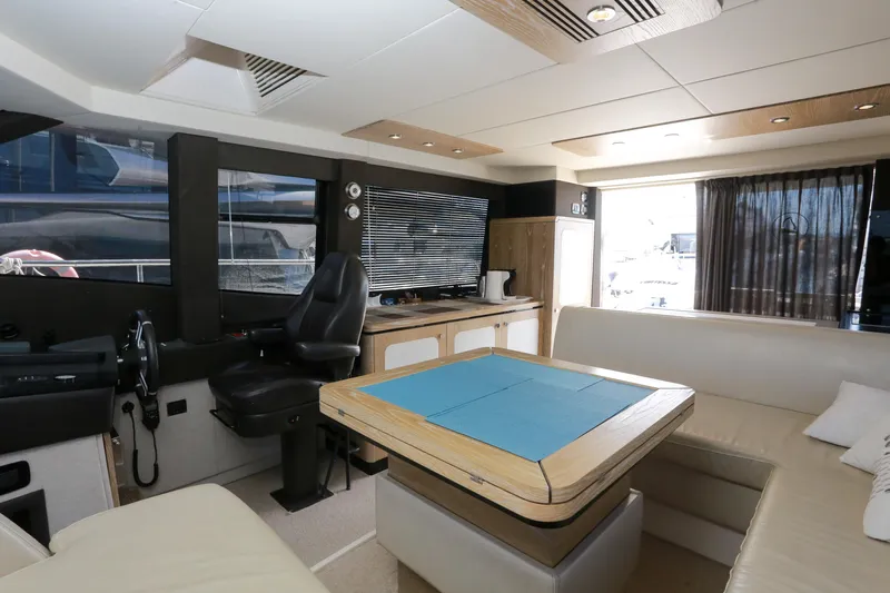  Yacht Photos Pics Luxurious interior of 2019 Azimut Magellano 53 yacht with seating and navigation area.