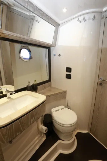  Yacht Photos Pics Luxurious bathroom in 2019 Azimut Magellano 53 yacht, featuring modern fixtures and elegant design.