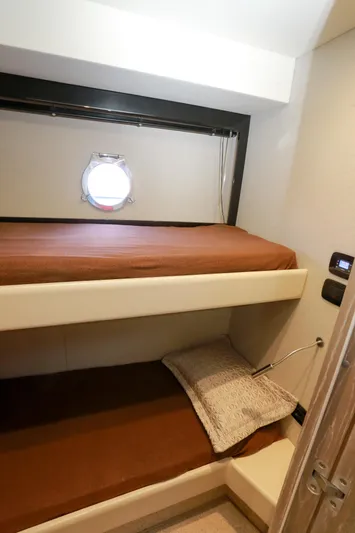  Yacht Photos Pics Cabin interior of 2019 Azimut Magellano 53 yacht with bunk beds and porthole.